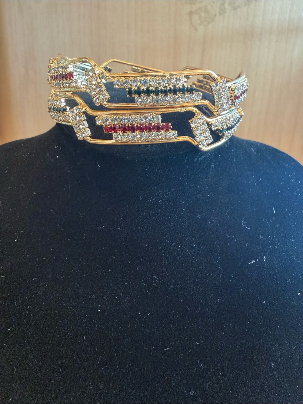 Gold toned red green and white rhinestone bangle set